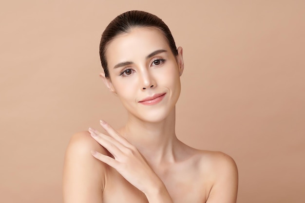Beautiful young asian woman with clean fresh skin on beige background face care facial treatment cosmetology beauty and spa asian women portrait Premium Photo