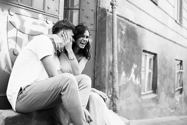 Beautiful and young boy and girl sits near doors