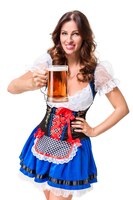 Free photo beautiful young brunette girl in dirndl drinks out of oktoberfest beer stein. isolated on white background.