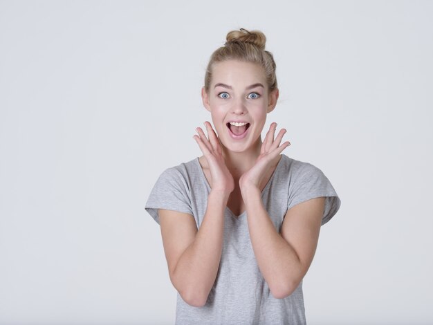 Beautiful young caucasian Surprised  woman on white background