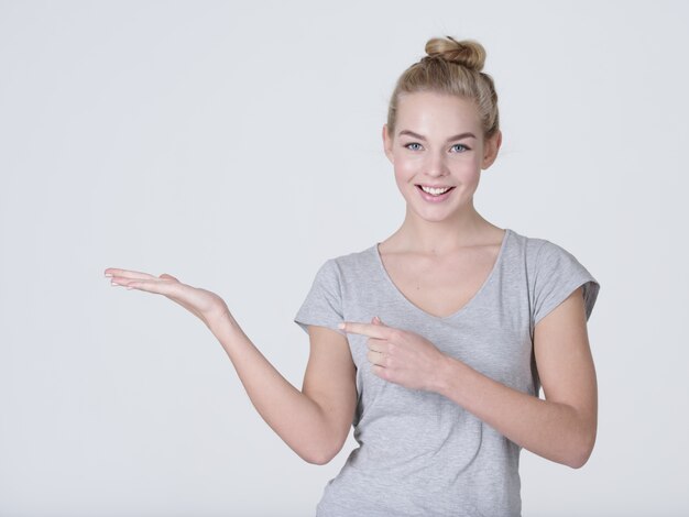 Beautiful young caucasian woman show palm hand isolated on white background