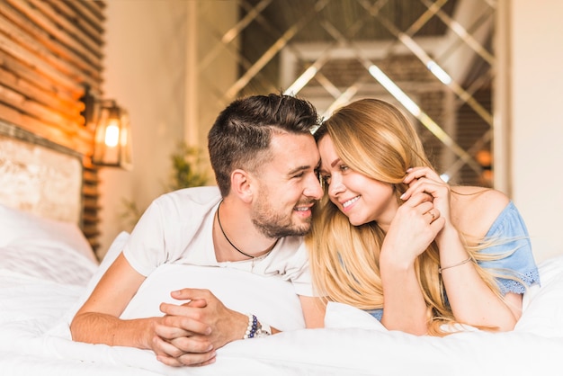 Beautiful young couple on bed