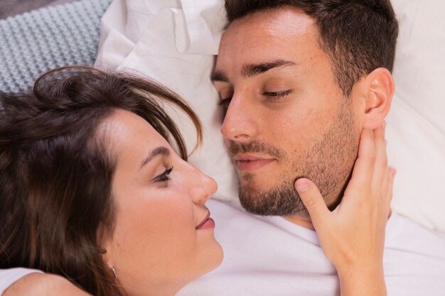 Beautiful young couple in bedroom