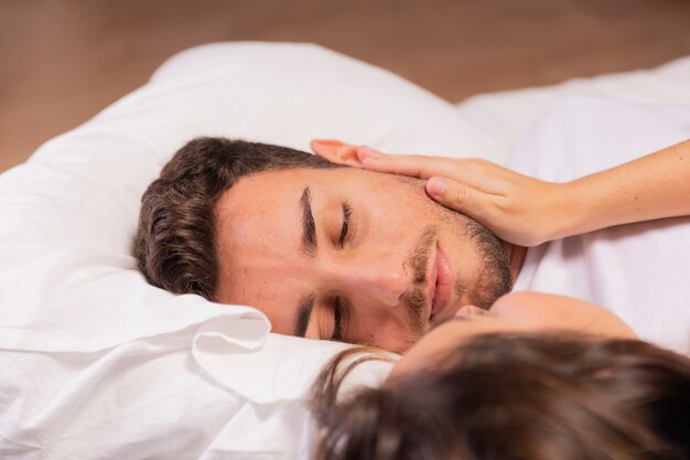 Beautiful young couple in bedroom