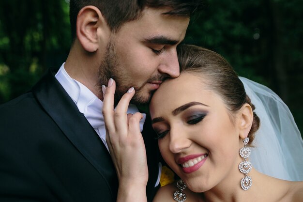 Beautiful young couple posing in the forest from close angle