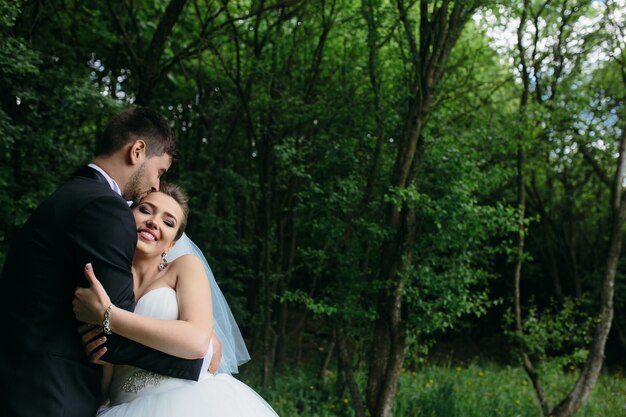 Beautiful young couple posing in the forest from close angle