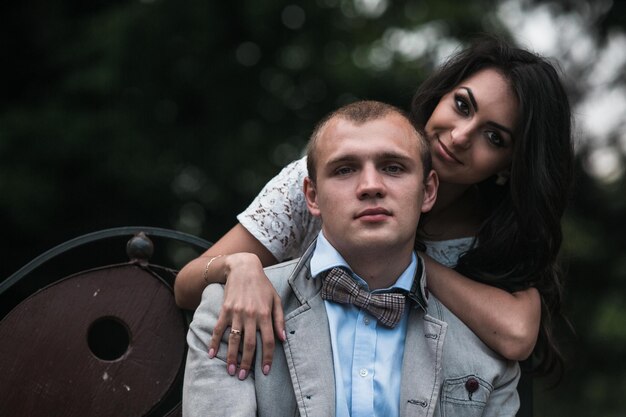 Beautiful young couple relaxing in the park and makes selfie