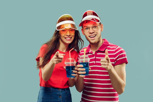 Beautiful young couple's half-length portrait isolated on blue