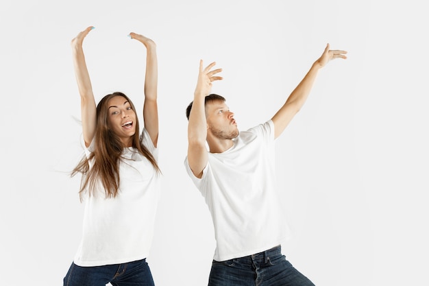 Beautiful young couple's portrait isolated on white  space. Facial expression, human emotions, advertising concept. Copyspace