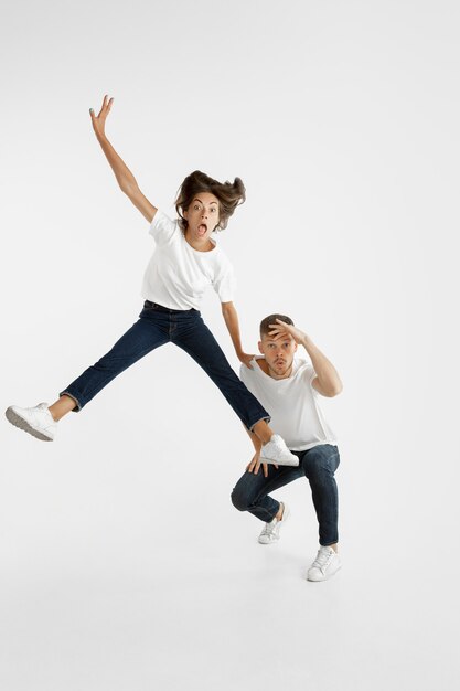 Beautiful young couple's portrait on white studio