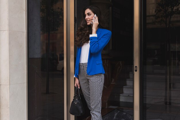 Beautiful young employee talking on the phone