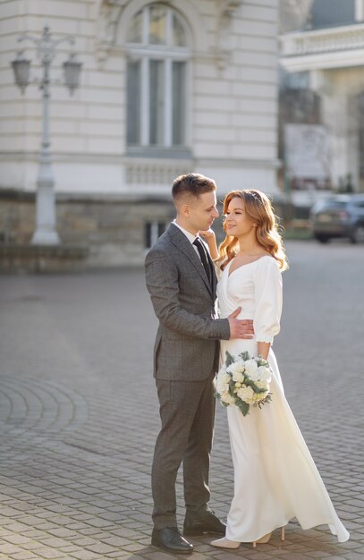 Beautiful young fashion stylish couple walking on the street in city