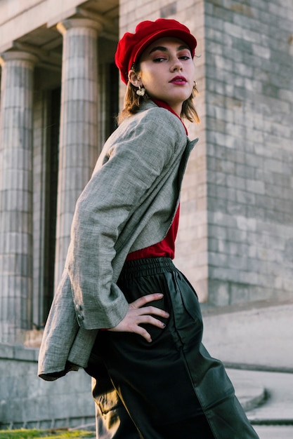 Beautiful young female model posing in front of building