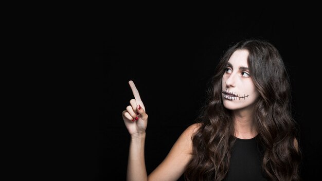 Beautiful young female with scarecrow makeup