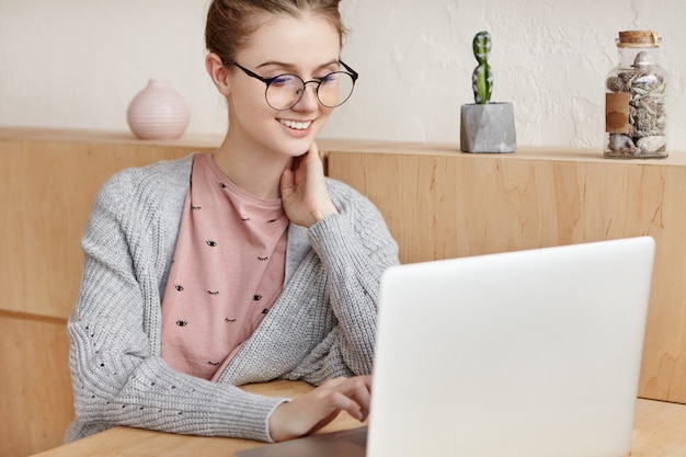 Beautiful young female working with laptop