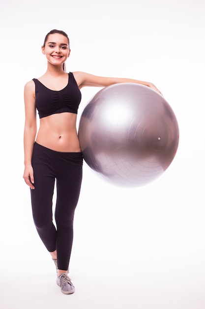 Free photo beautiful young fitness woman with gym ball exercising, isolated on white background