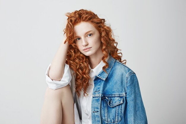 Beautiful young foxy girl with freckles posing .