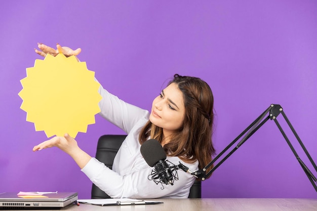 Beautiful young girl holding idea bubble in a sun shape high quality photo