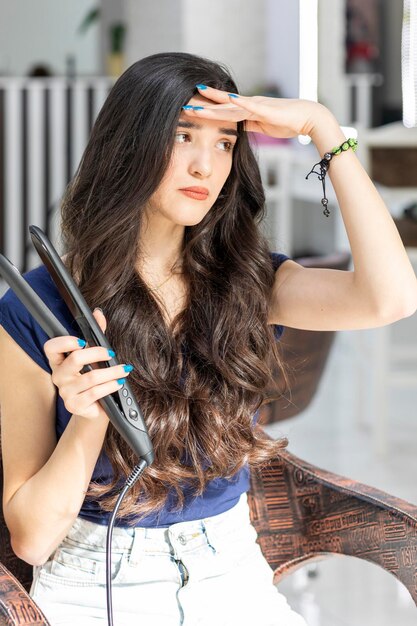 Beautiful young girl puts her hand to her forehead and look aside in barbershop High quality photo