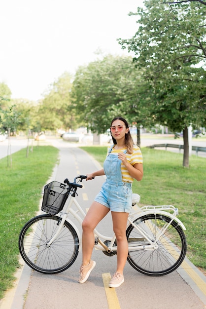 Beautiful young girl riding bike outdoors