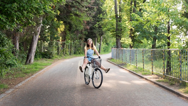 Beautiful young girl riding bike outdoors