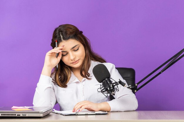 Beautiful young girl sitting behind the desk and taking her notes High quality photo