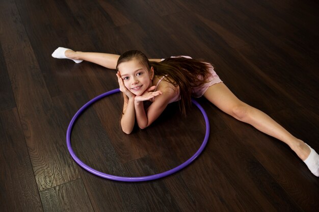 Beautiful young girl using hula hop