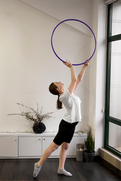 Beautiful young girl using hula hop