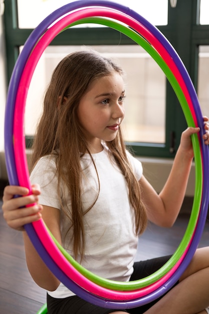 beautiful young girl using hula hop