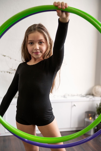beautiful young girl using hula hop