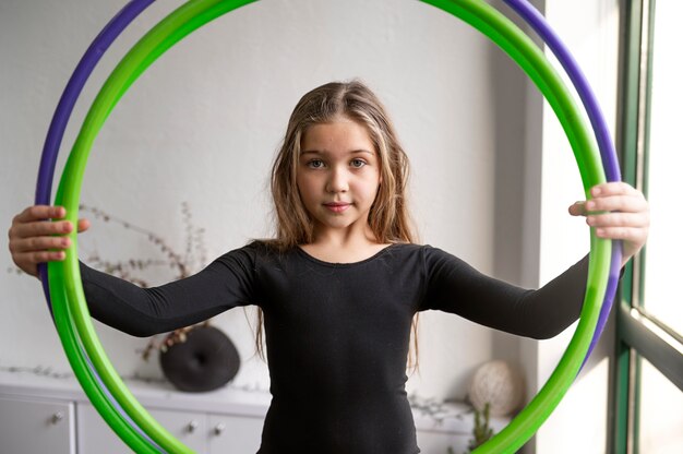 beautiful young girl using hula hop