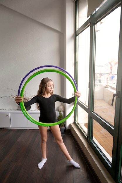 Beautiful young girl using hula hop