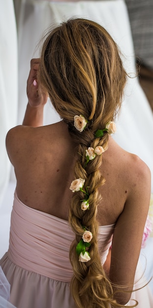 beautiful young girl with long hair flowers the tenderness of the mystery in a braid steed back