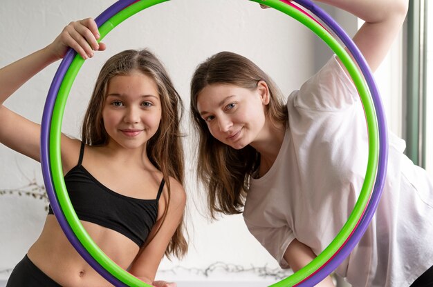 Beautiful young girls using hula hop