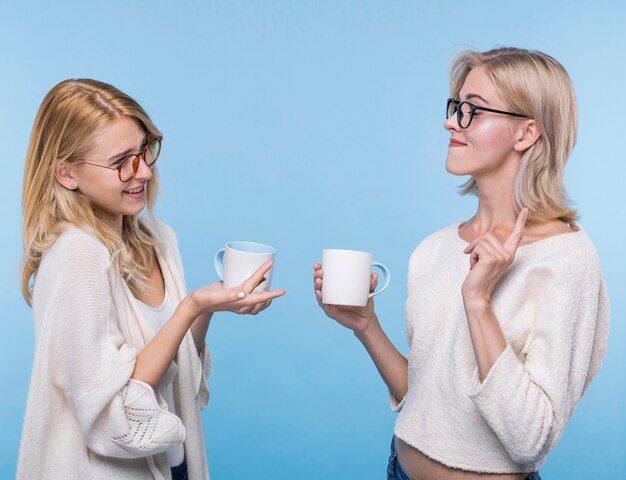 Beautiful young girls with coffee mugs