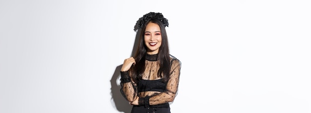 Free photo beautiful young happy woman enjoying halloween party smiling and looking cheerful while wearing her