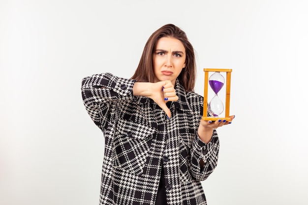 Beautiful young lady love holding hourglass and gesture thumb down