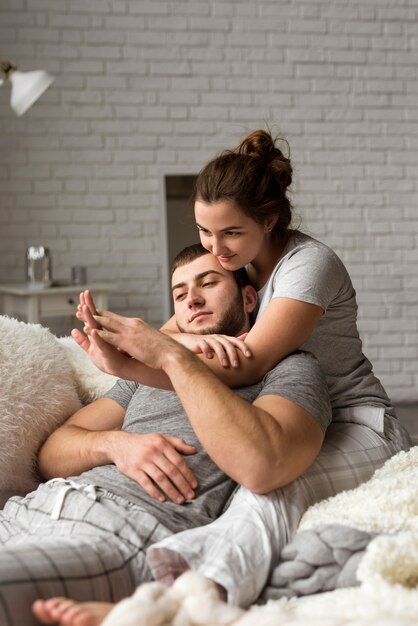 Beautiful young man and woman together indoors