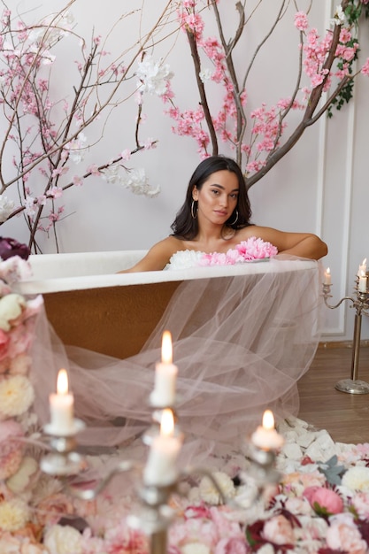 Free photo beautiful young model sittin in a bathtub and looking at the camera high quality photo