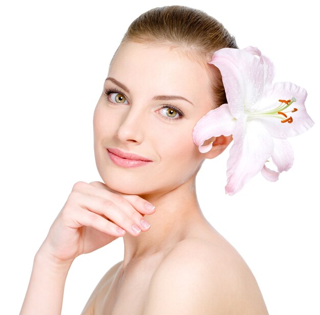 Beautiful young pretty woman with flower in hair 