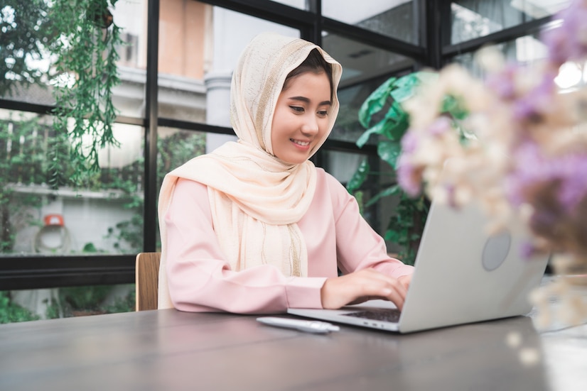 Free Photo | Beautiful young smiling asian muslim woman working on ...