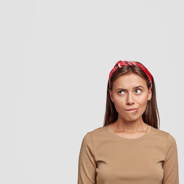 beautiful young student posing against the white wall