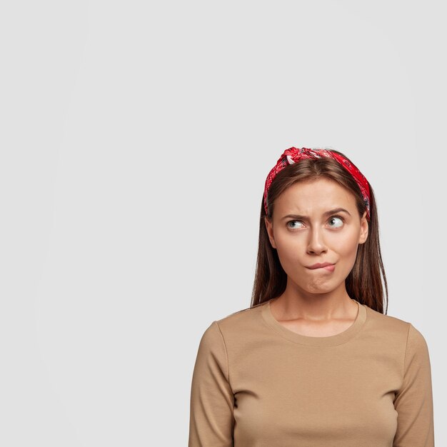 beautiful young student posing against the white wall