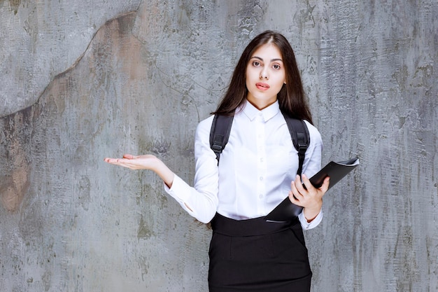 Beautiful young student wearing school uniform against wall. High quality photo