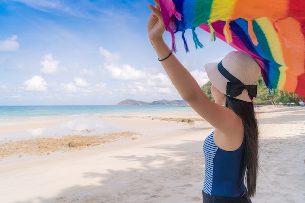 Beautiful young woman on beach with scarf