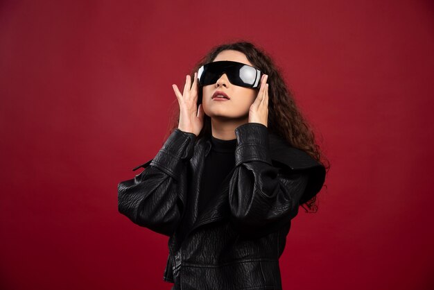 Beautiful young woman in black glasses.