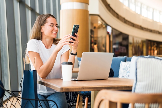 Free photo beautiful young woman browsing mobile phone