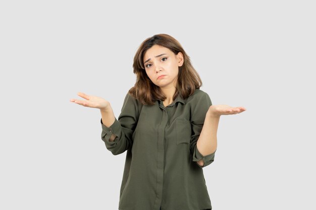 Beautiful young woman in casual outfit showing her opened palms