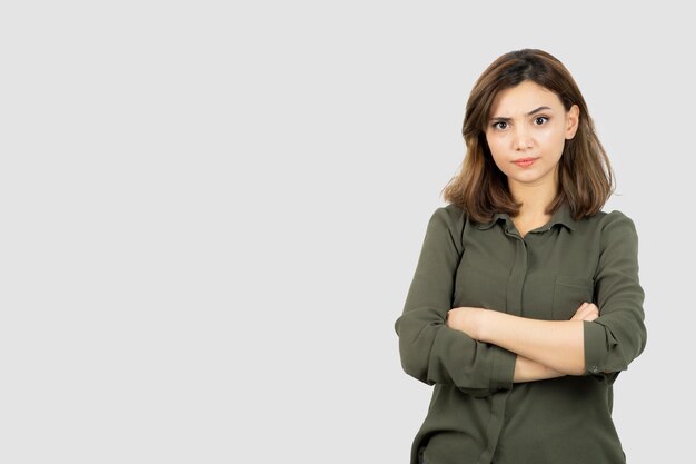 Beautiful young woman in casual outfit standing arms crossed