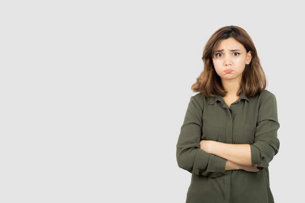 Beautiful young woman in casual outfit standing arms crossed